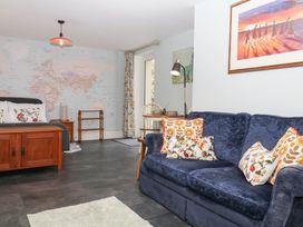 A living room with a sofa and bed at Little Moorgate Okehampton