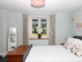 A bedroom with a bed and a window at Little Moorgate in Okehampton