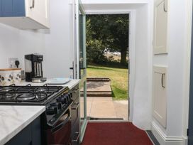 A kitchen with a gas stove and coffee maker at Little Moorgate in Okehampton