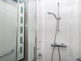 A shower with a glass door and chrome fixtures at Little Moorgate Okehampton