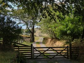 A path leading through trees with a gate at Little Moorgate Okehampton