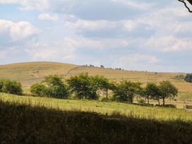 A view of hills and trees with a cloudy sky at Little Moorgate in Okehampton