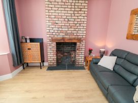 A living room with a fireplace and sofa at Portobell House in Bridlington