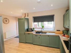A kitchen with cabinets and appliances at Portobell House in Bridlington