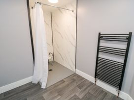 A wet room with a shower and towel rail at Portobell House in Bridlington