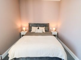 A bedroom with a bed and bedside tables at Portobell House in Bridlington