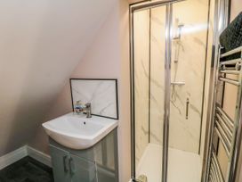 A bathroom with a shower enclosure and wash basin at Portobell House in Bridlington