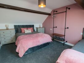 A bedroom with a bed, nightstands, and a dresser at Portobell House in Bridlington