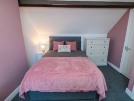 A bedroom with a bed and a chest of drawers at Portobell House in Bridlington