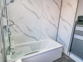 A bathroom with a bathtub and shower at Portobell House in Bridlington
