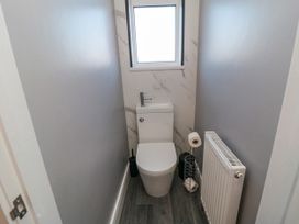 A bathroom with a toilet and radiator at Portobell House in Bridlington