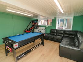 A game room with a pool table and sofa at Portobell House in Bridlington
