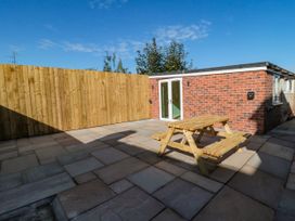An outdoor area with a picnic table and wooden fence at Portobell House in Bridlington
