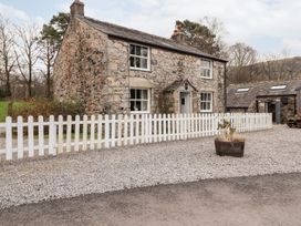 A house with a white fence and gravel pathway at Irt Cottage in Seascale