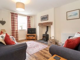 A living room with a television and fireplace at Irt Cottage in Seascale