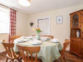 A dining room with a table set for a meal at Irt Cottage in Seascale