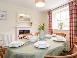 A dining room with a table set for a meal at Irt Cottage Seascale