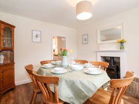 A dining room with a table set for meals at Irt Cottage Seascale