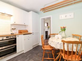 A kitchen with a table and chairs at Irt Cottage in Seascale