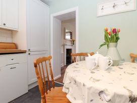 A kitchen with a table and chairs at Irt Cottage in Seascale
