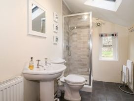 A bathroom with a sink, toilet, and shower at Irt Cottage in Seascale