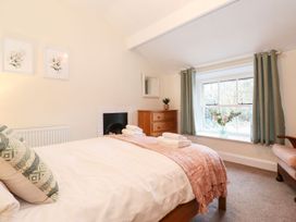 A bedroom with a bed and window at Irt Cottage in Seascale