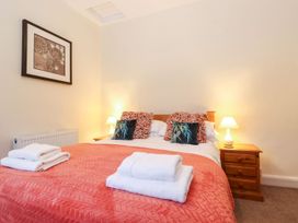A bedroom with a bed and bedside table at Irt Cottage in Seascale