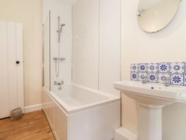 A bathroom with a bathtub and sink at Irt Cottage Seascale