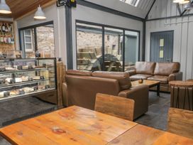 A cafe with couches and a display case at Irt Cottage in Seascale