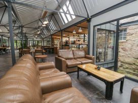 A seating area with a sofa and coffee table at Irt Cottage Seascale