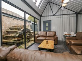 A snug with a coffee table and sofas at Irt Cottage in Seascale