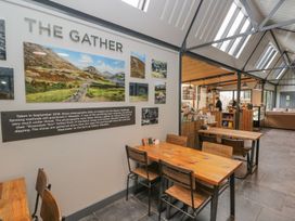 A café with tables and chairs and a counter at Irt Cottage Seascale