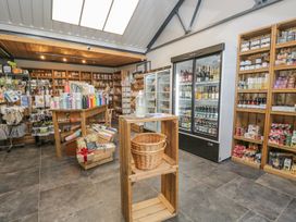 A store with shelving units and a cooler at Irt Cottage Seascale