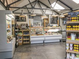 A café with display case and shelves at Irt Cottage in Seascale