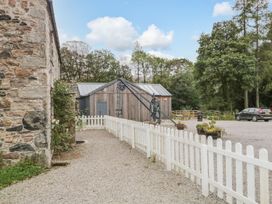 An outdoor area with a gravel pathway and a wooden shed at Irt Cottage Seascale