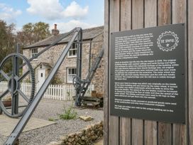 An outdoor view of a sawmill with a water wheel at The Sawmill in Wasdale