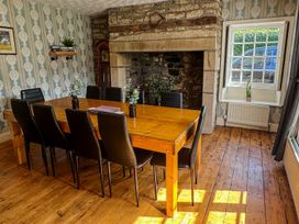 A dining room with a table and chairs at Prudhoe Cottage in Prudhoe