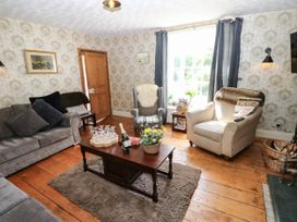 A living room with a sofa and armchair at Prudhoe Cottage in Prudhoe