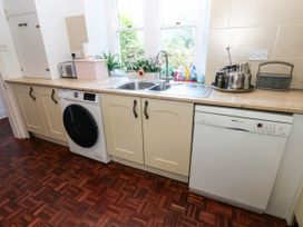 A kitchen with a sink, washing machine, and dishwasher at Prudhoe Cottage in Prudhoe