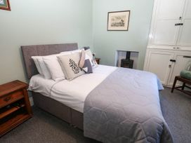 A bedroom with a bed and bedside furniture at Prudhoe Cottage Prudhoe