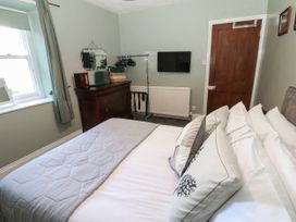A bedroom with a bed and a television at Prudhoe Cottage in Prudhoe