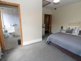 A bedroom with a view into the bathroom at Prudhoe Cottage in Prudhoe