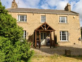 A house with a porch and garden at Prudhoe Cottage in Prudhoe
