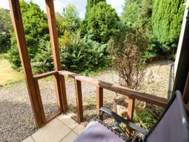 A garden view with plants and a chair at Prudhoe Cottage in Prudhoe