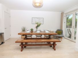 A dining room with a wooden table and chairs at Beachstone in Salcombe