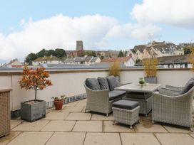 An outdoor space with furniture and plants at Beachstone in Salcombe