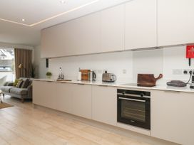 A kitchen with cabinets and appliances at Beachstone in Salcombe