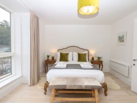 A bedroom with a bed and nightstand at Beachstone in Salcombe
