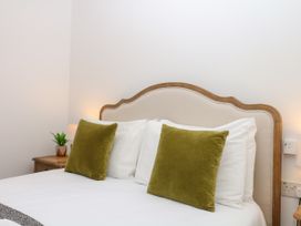 A bedroom with a bed and pillows at Beachstone in Salcombe