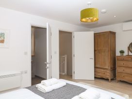 A bedroom with a bed and a cabinet at Beachstone in Salcombe
